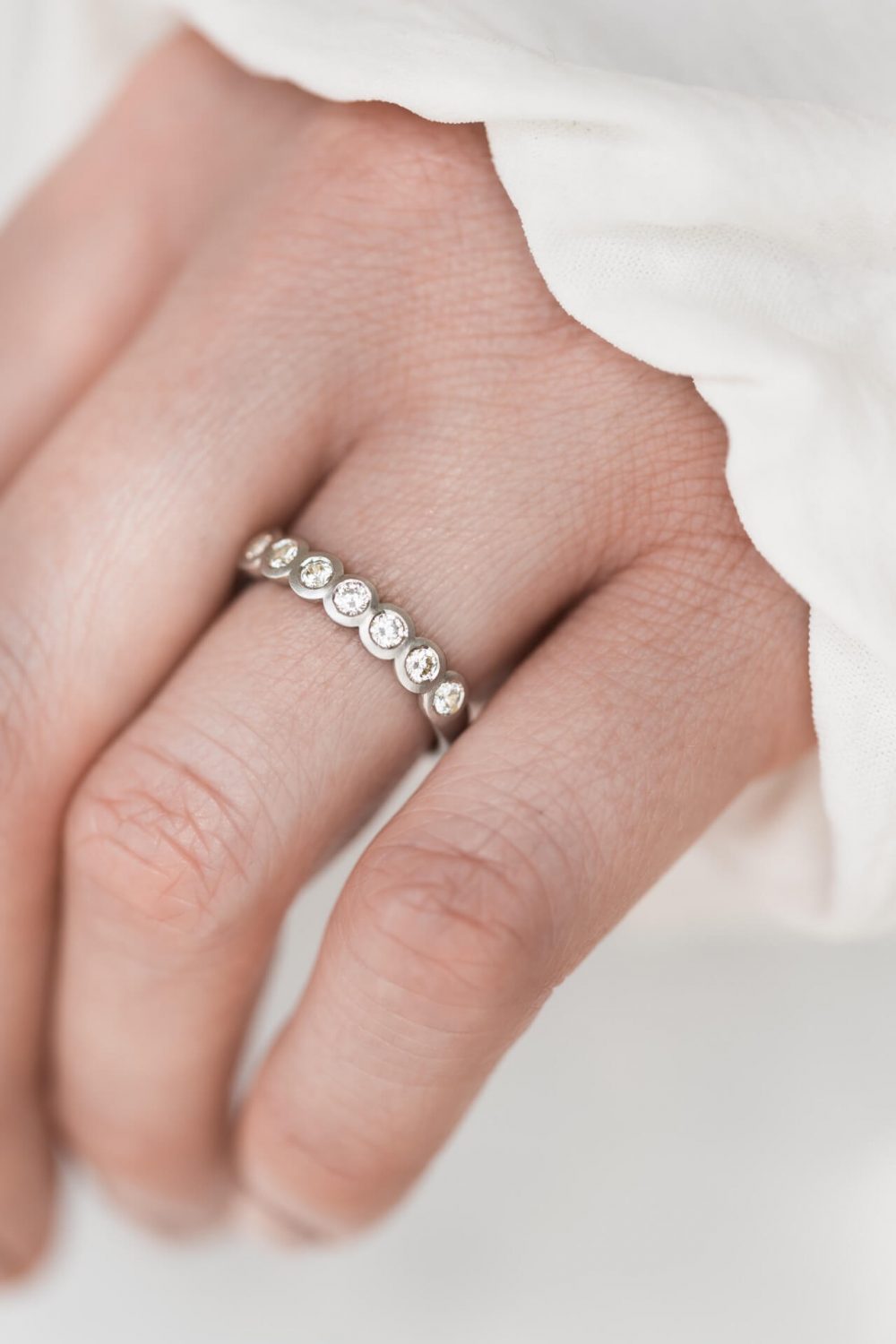 Diamond Eternity Ring On Models Wedding Finger. Contemporary Diamond Ring.