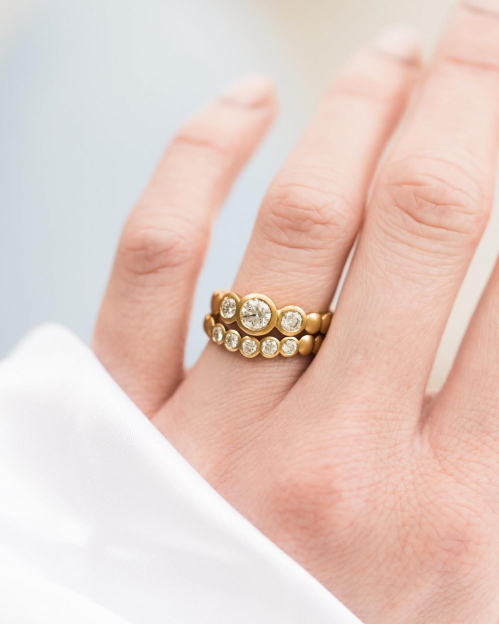 Diamond Trilogy Engagement Ring On Models Finger. Handmade By Bristol Jeweller Jacks Turner
