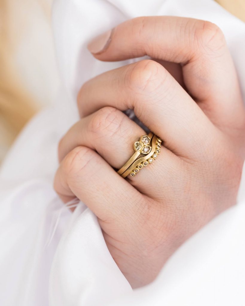 Geo Diamond Cluster Ring With Curved Diamond Wedding Ring On Bride. Jacks Turner Bristol. Bespoke Engagement Rings.