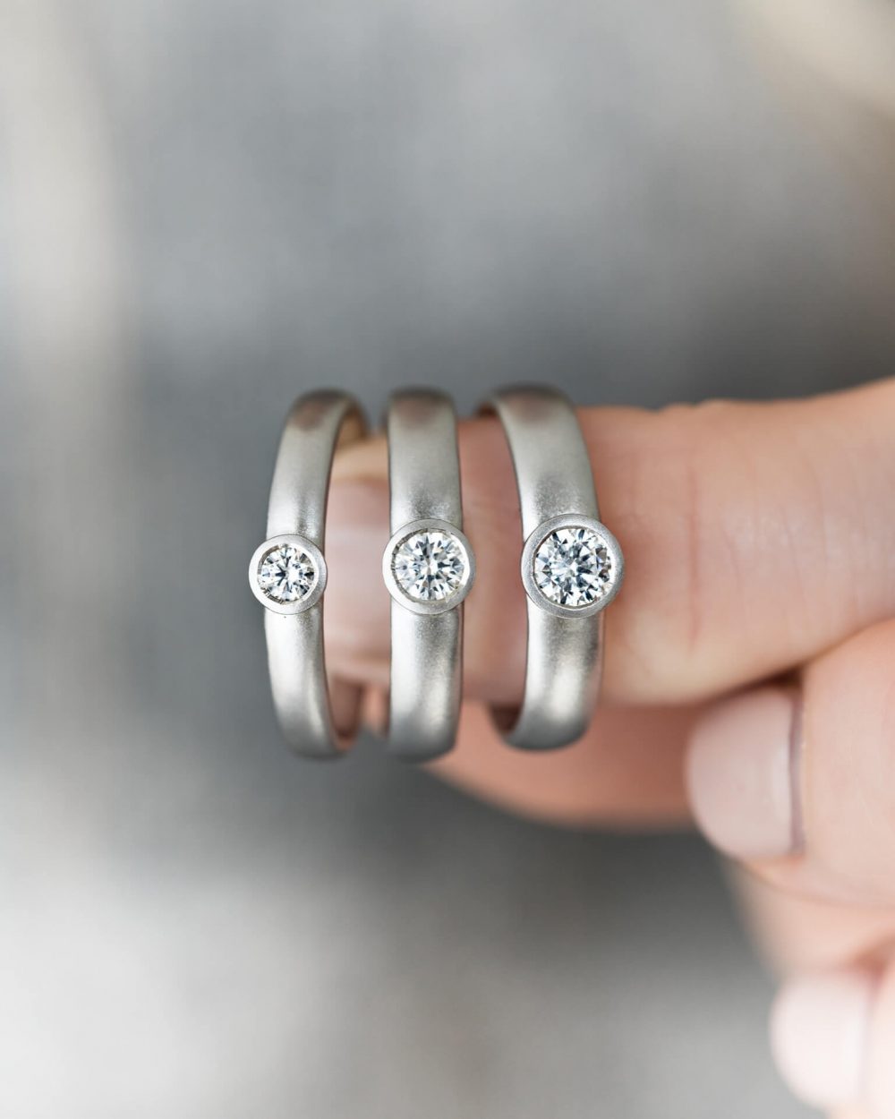 Three Sizes Diamond Engagement Ring On Finger Jacks Turner Bristol