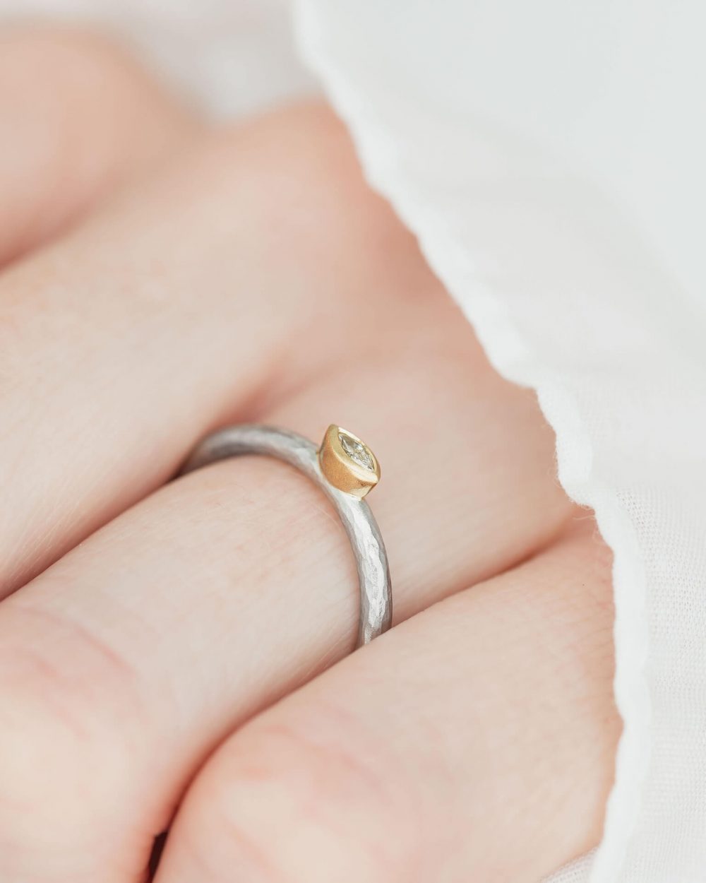 Marquise Diamond Ring Handmade In Hammered Textured Platinum, With A Yellow Gold Setting. Pictured On Model, Side View. Engagement Ring Designed By Jacks Turner Bristol Jeweller.