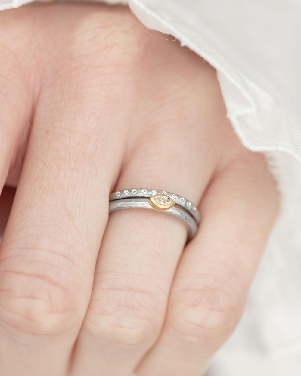 Marquise Diamond Ring Handmade In Hammered Textured Platinum, With A Yellow Gold Setting. Pictured On Model With A Matching Platinum Diamond Wedding Ring. Engagement Ring Designed By Jacks Turner Bristol Jeweller.