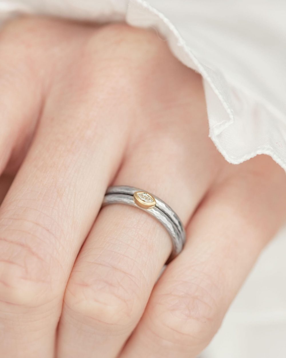 Marquise Diamond Ring Handmade In Hammered Textured Platinum, With A Yellow Gold Setting. Pictured On Model With A Matching Platinum Wedding Ring. Engagement Ring Designed By Jacks Turner Bristol Jeweller.
