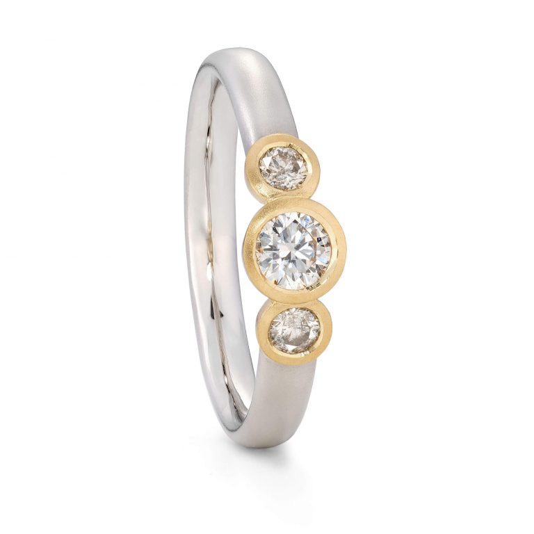 Three Diamond engagement ring handmade in platinum with 18ct yellow gold settings. Designed by Jacks Turner Bristol jeweller.