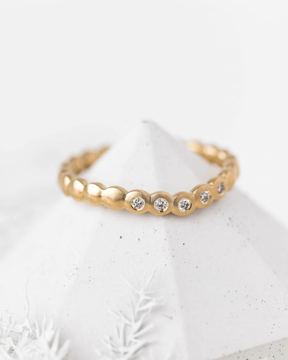 Mini Cups Curved Diamond Ring Handmade In Yellow Gold And Set With Five Sparkle Diamonds. Pictured On A Cone. Handmade By Bristol Jeweller Jacks Turner.