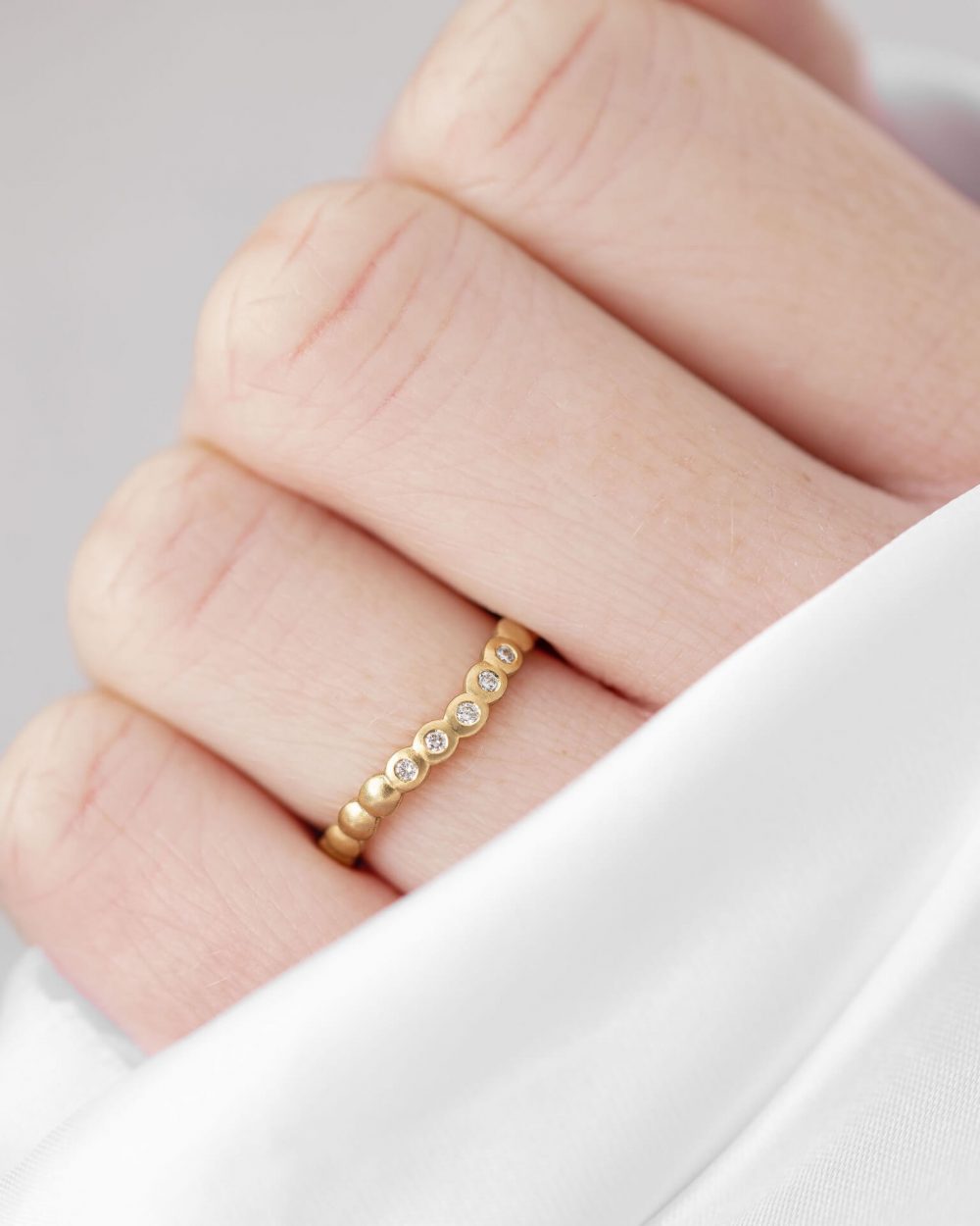 Mini Cups Curved Diamond Ring Handmade In Yellow Gold And Set With Five Sparkle Diamonds. Worn By Model (2). Handmade By Bristol Jeweller Jacks Turner.