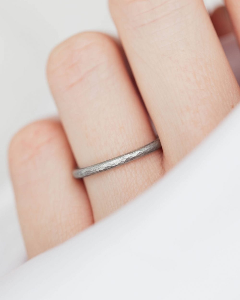 Hammered Platinum Wedding Ring, Set With Ten Sparkle Diamonds, Shown Worn On Model. Designed By Bristol Jeweller Jacks Turner.