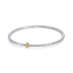 Eternity silver bangle with gold diamond bead. Designed by Jacks Turner contemporary jewellery Bristol.