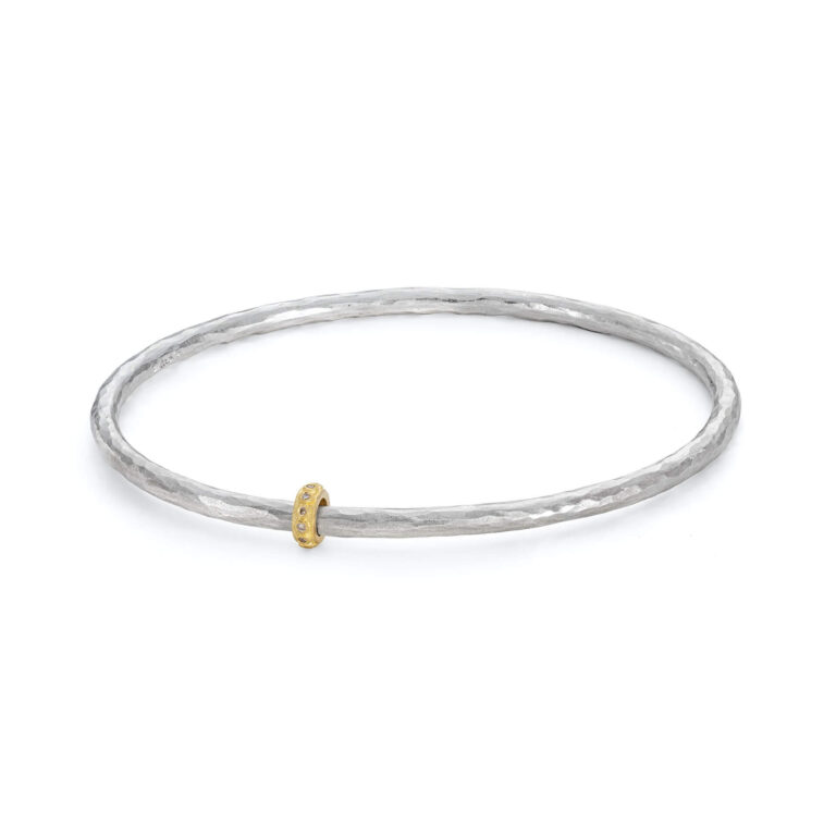 Eternity silver bangle with gold diamond bead. Designed by Jacks Turner contemporary jewellery Bristol.