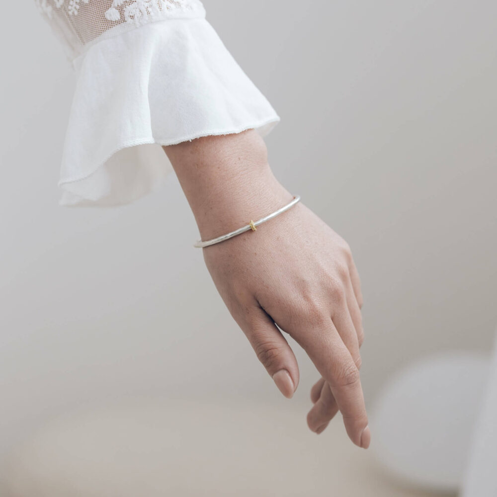 Eternity Silver Bangle With Gold Diamond Bead On Model. Designed By Bristol Contemporary Jeweller Jacks Turner.