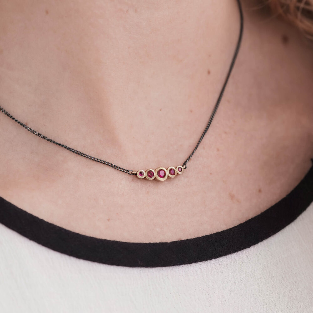 Bijou Five Ruby Necklace On Model. Designed By Bristol Jeweller Jacks Turner.