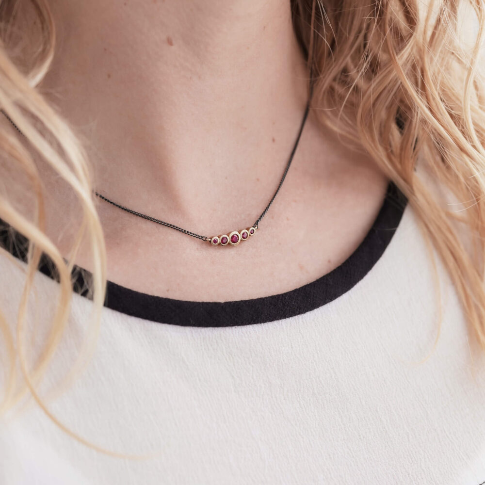 Bijou Five Ruby Necklace On Model. Designed By Bristol Jeweller Jacks Turner.